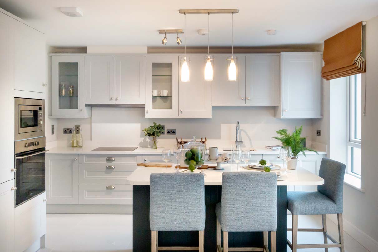 Contemporary-styled kitchen. Satin chrome sockets above worktops. Extractor fan.